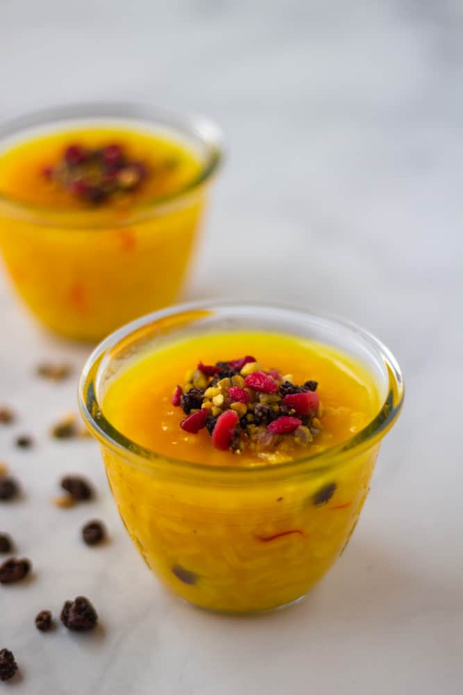 Vegan Turmeric Rice Pudding in small cups. Orange, jello-looking dessert.