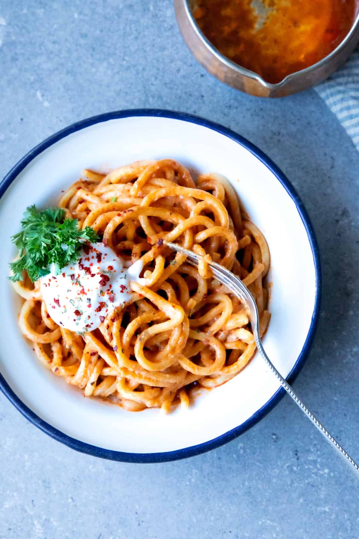 manti style pasta sauce on a plate with yogurt and herbs