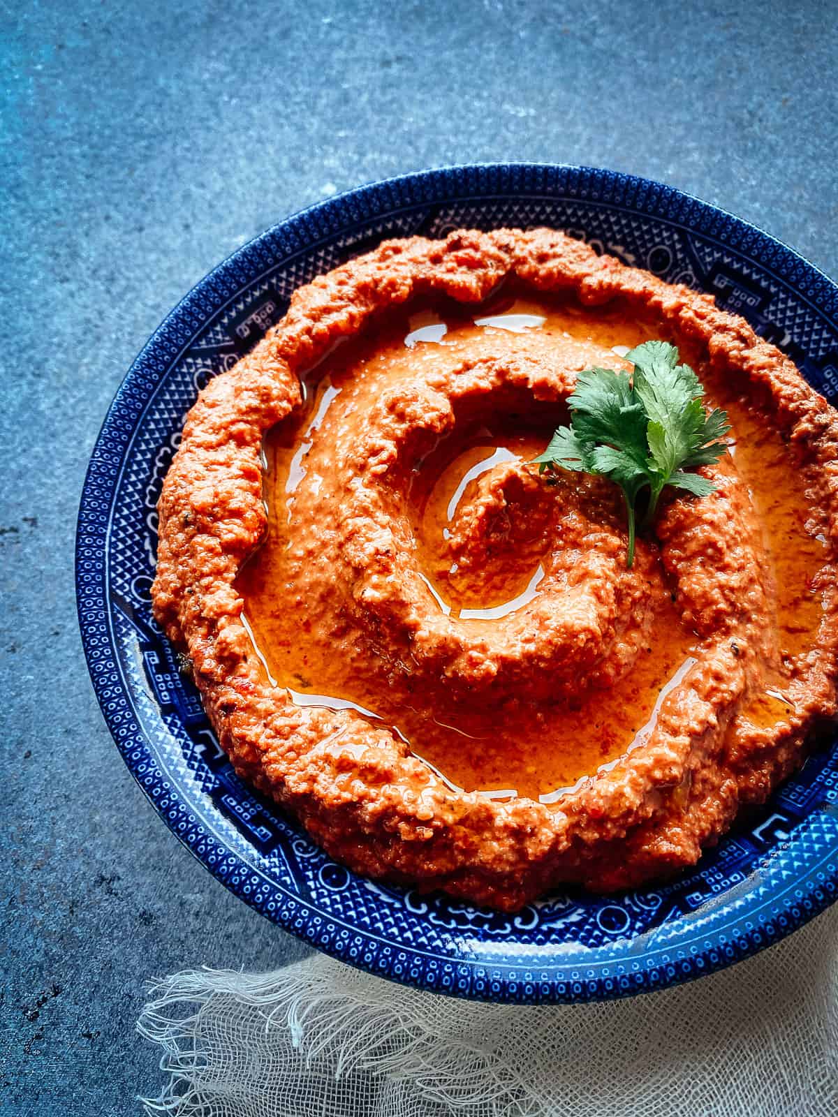 roasted red pepper and walnut muhammara in a blue bowl