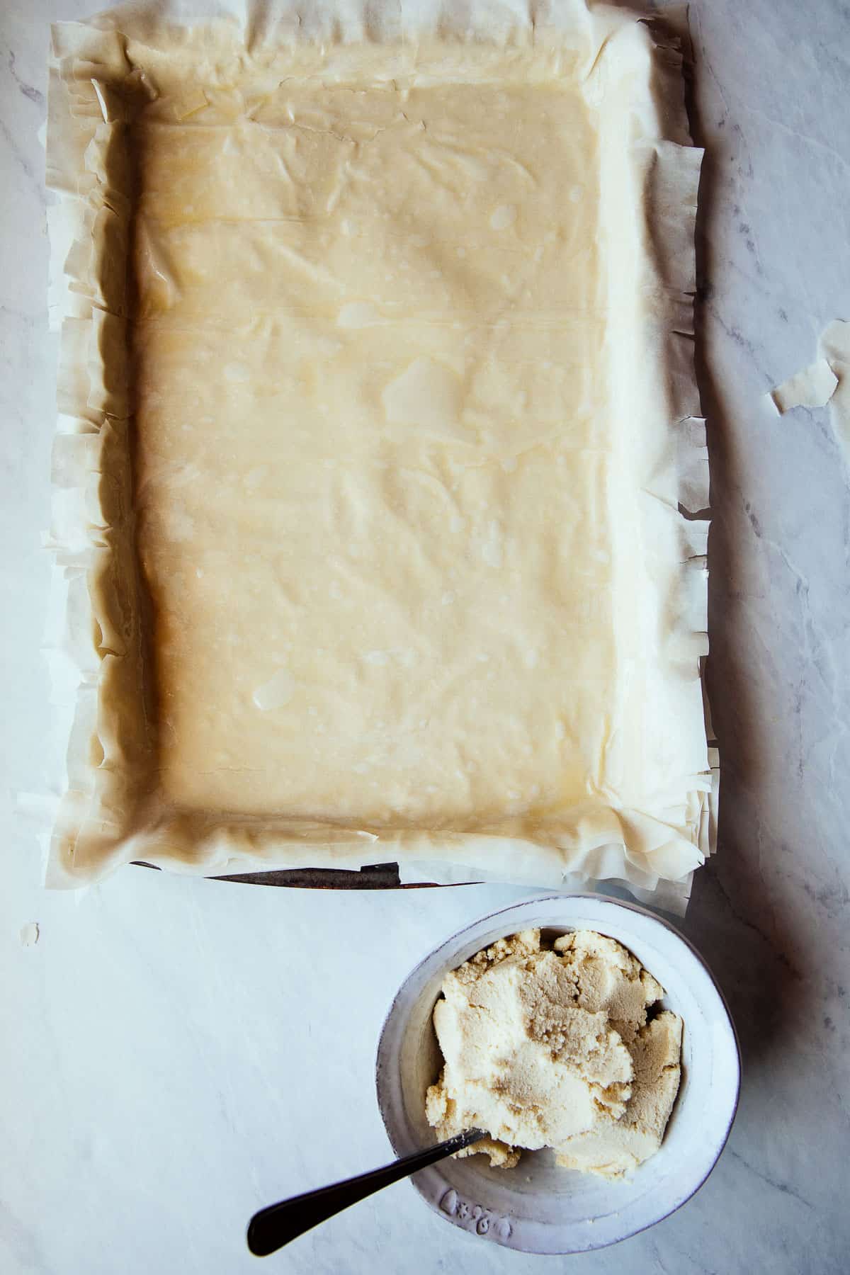 top view phyllo pastry layered onto baking sheet