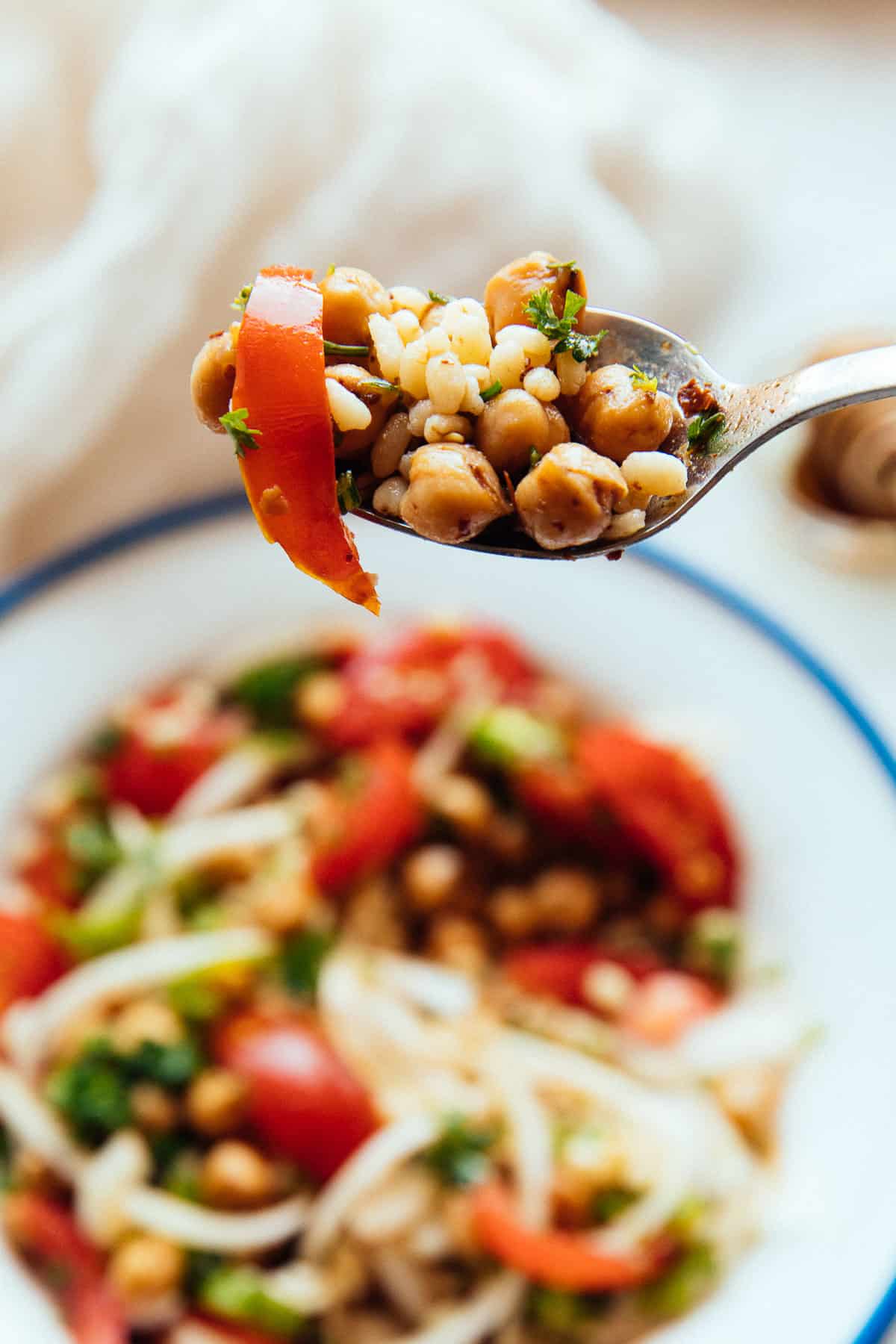 spicy chickpea and bulgur salad on a spoon from the side