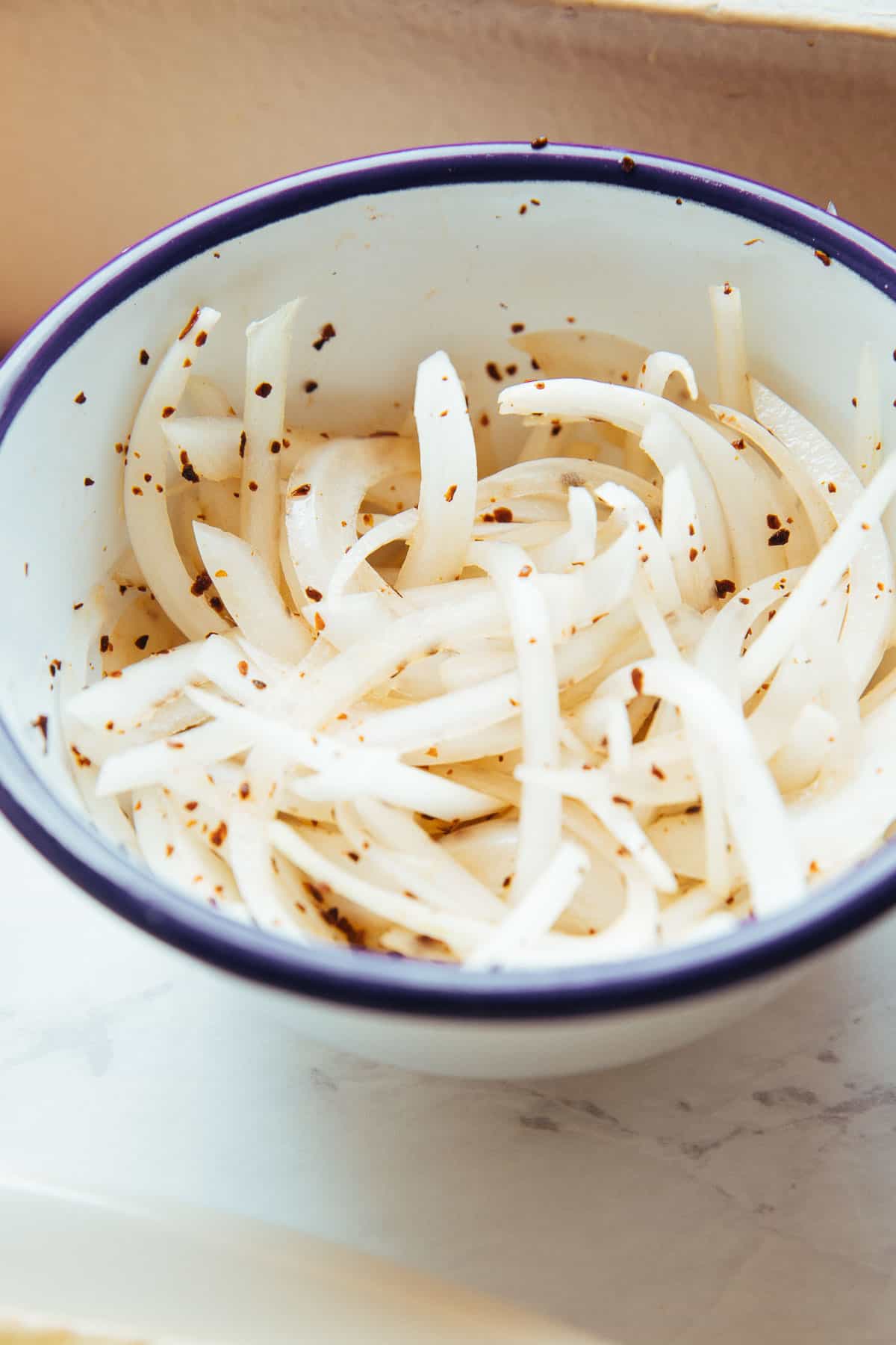 sliced onions with sumac in a bowl