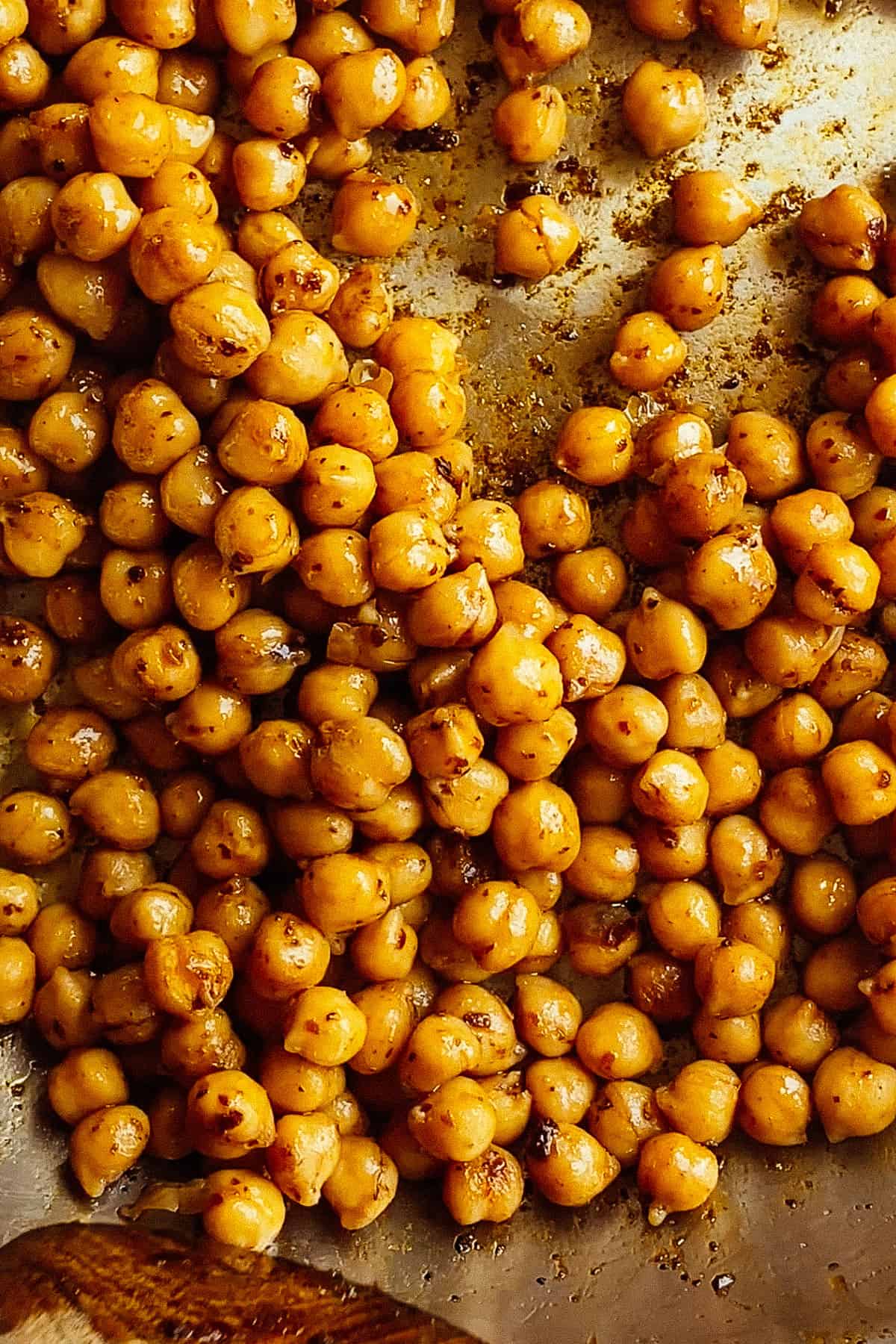 spicy chickpeas being stir fried in a pan