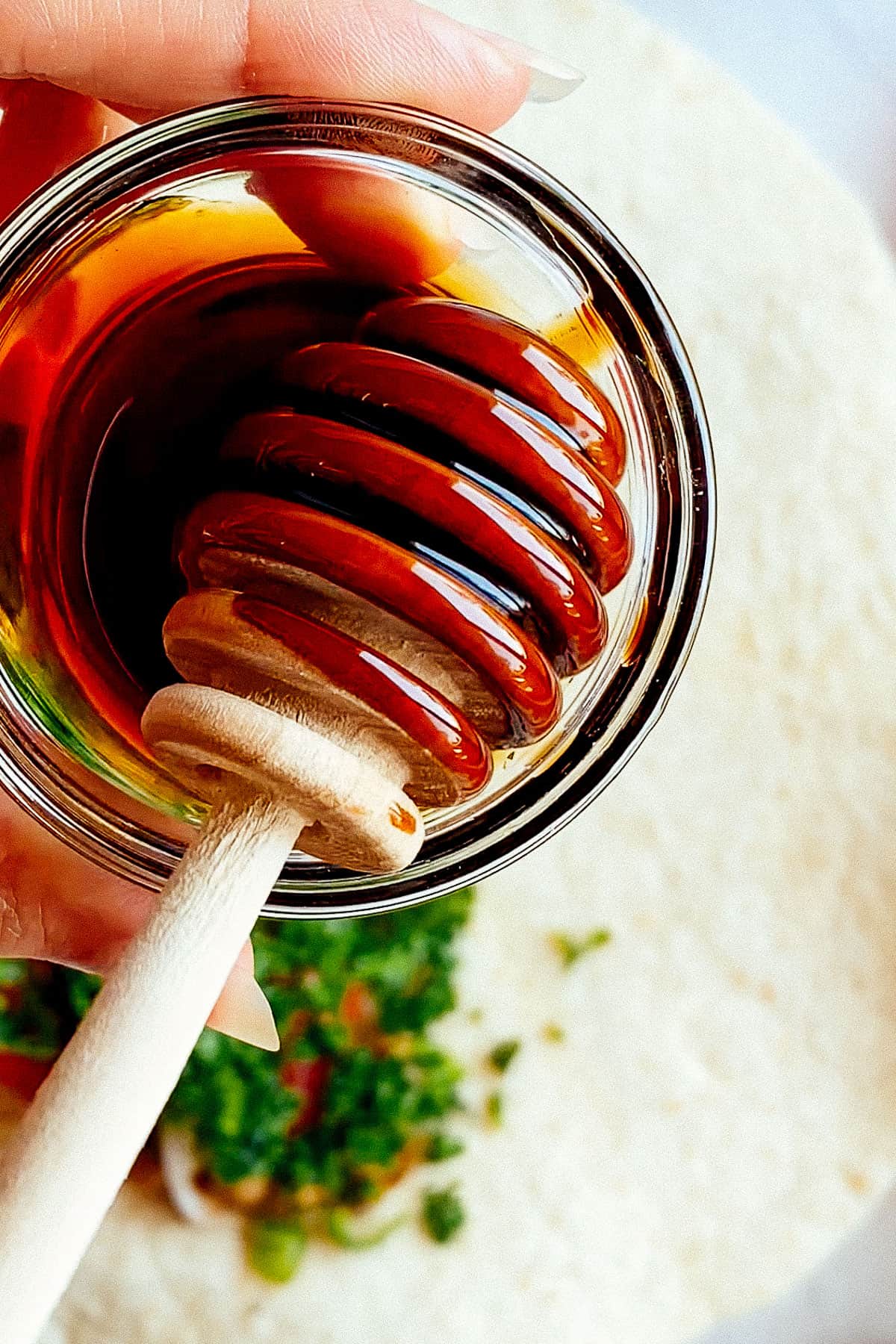 Pomegranate molasses with a honey spoon
