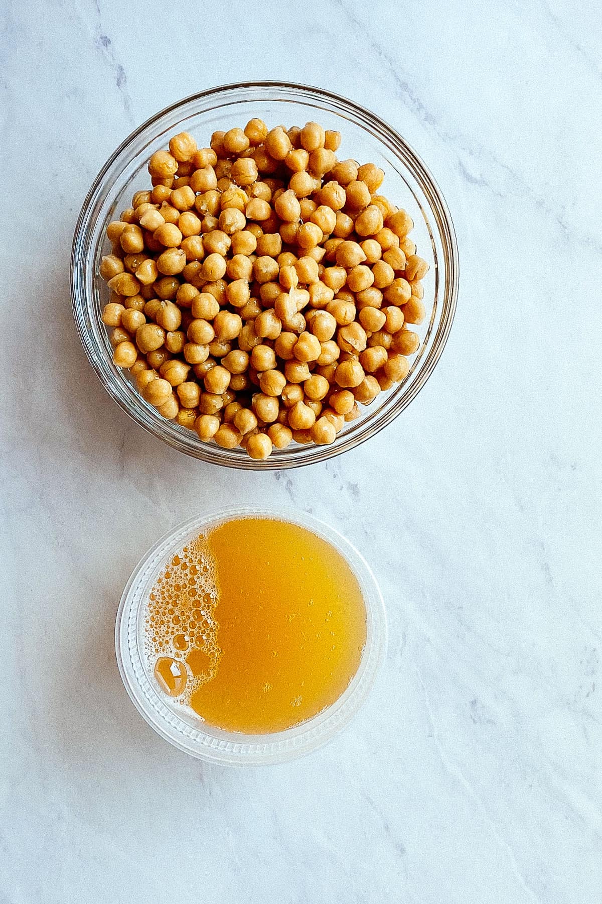 canned chickpeas and aquafaba side by side