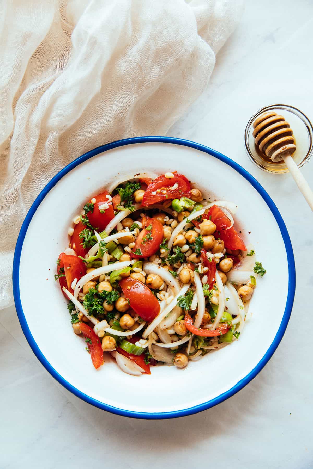spicy chickpea and bulgur salad in a bowl with a blue rim