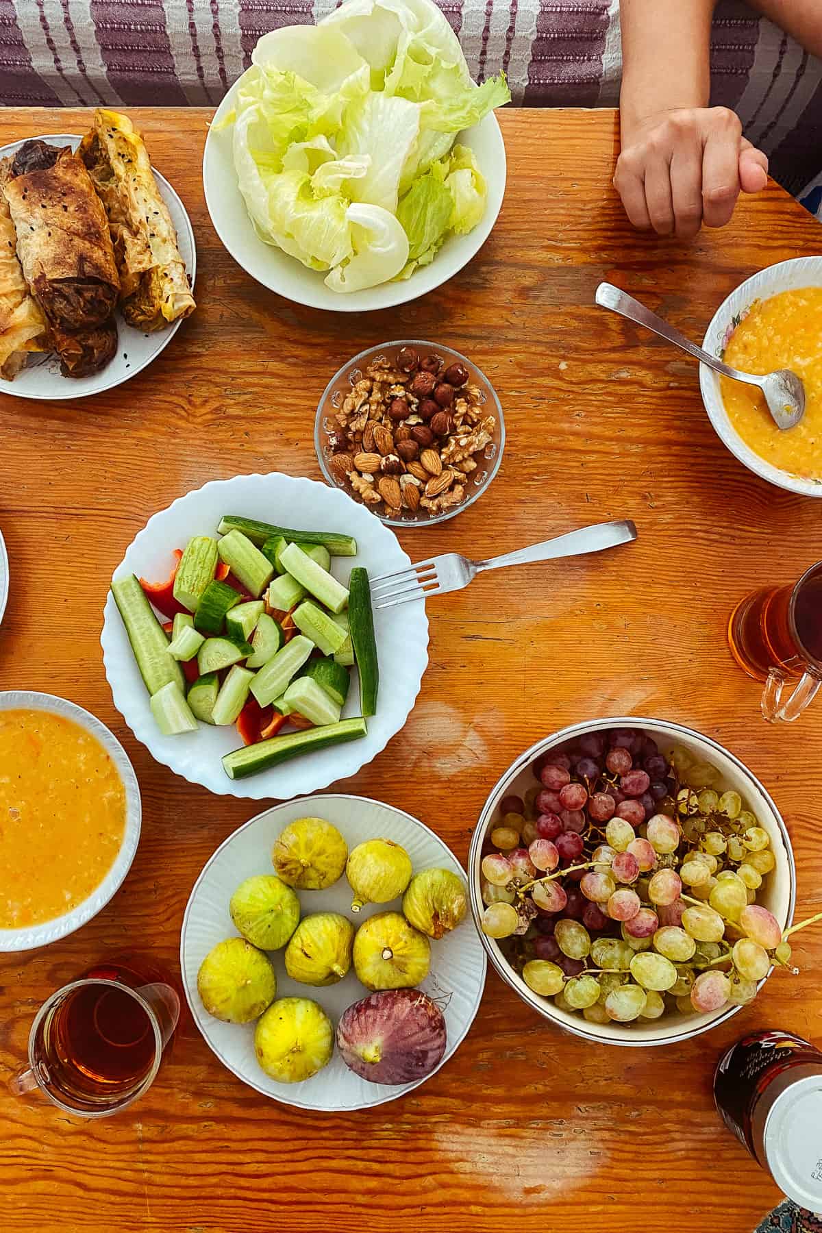 table with soup, figs, salad, turkish tea and borek from the top view