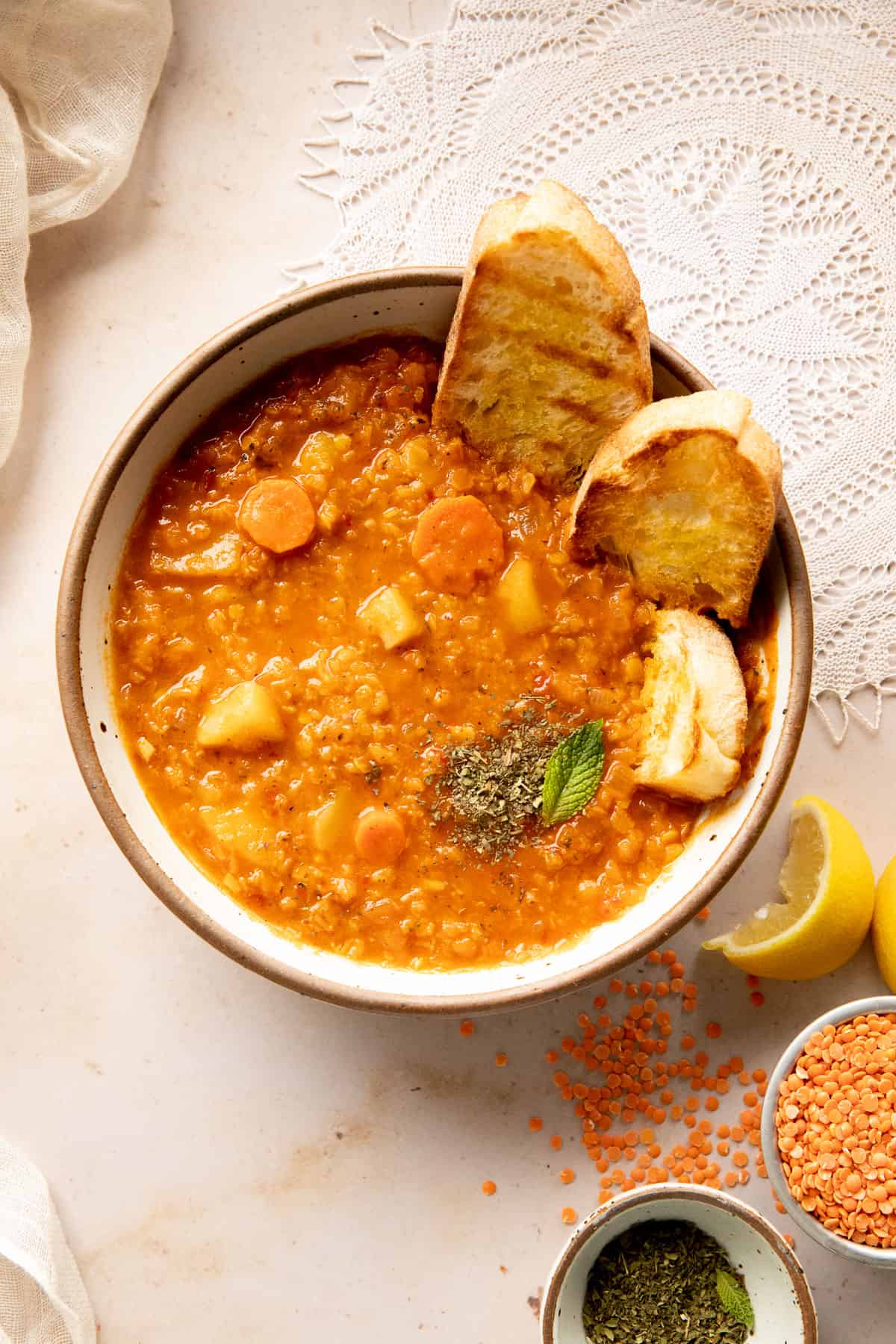 red lentil soup with lemon, red lentils, mint, and toasted bread