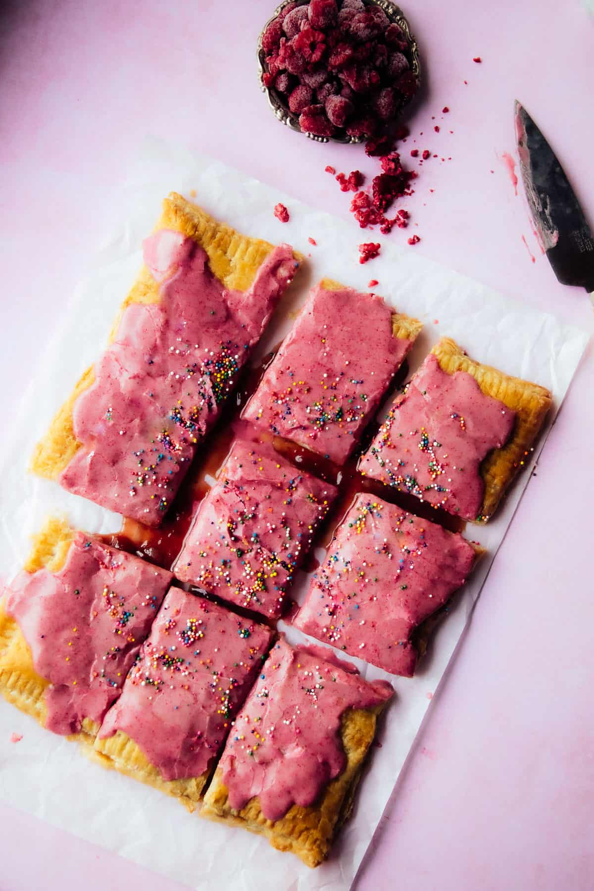 vegan pop tart, pink with sprinkles and freeze-dried raspberries on the side