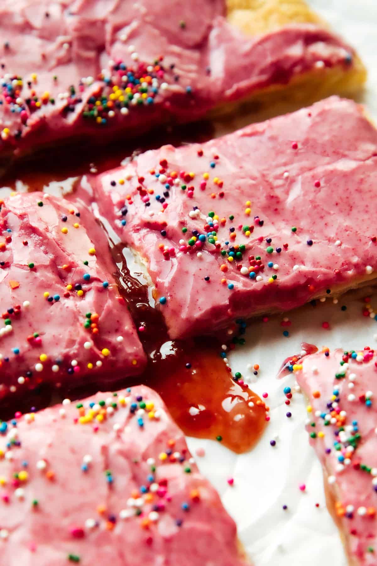 close up of vegan strawberry pop tart, oozing out strawberry preserves
